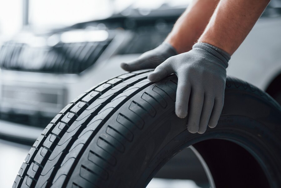 hands only mechanic holding tire repair garage replacement